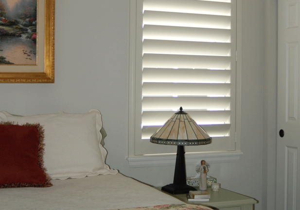 bedside windows with view through plantation shutters in Englewood CO