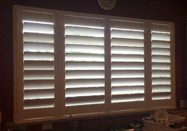 palm beach vinyl shutters on wide window in Denver CO