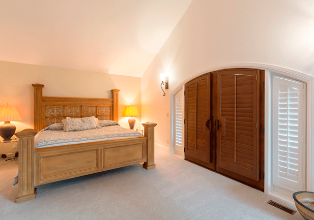 arched french doors with wood stain shutters in Denver CO