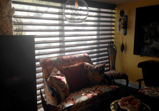 floor to ceiling window covered with brown pirouette shades in Westminster CO