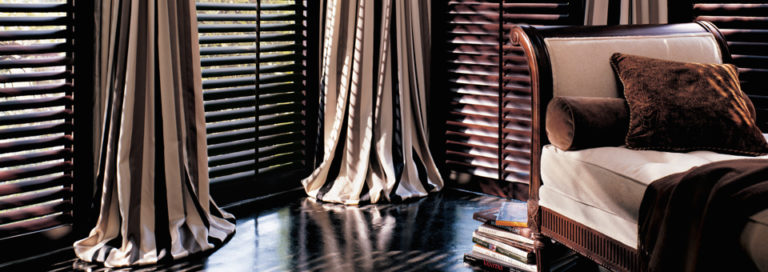 Plantation Shutters with puddled draperies in Denver CO