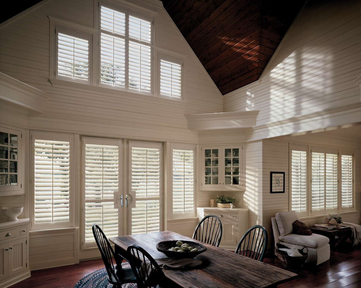 hard to reach windows in farmhouse style home with white wood shutters in Denver CO