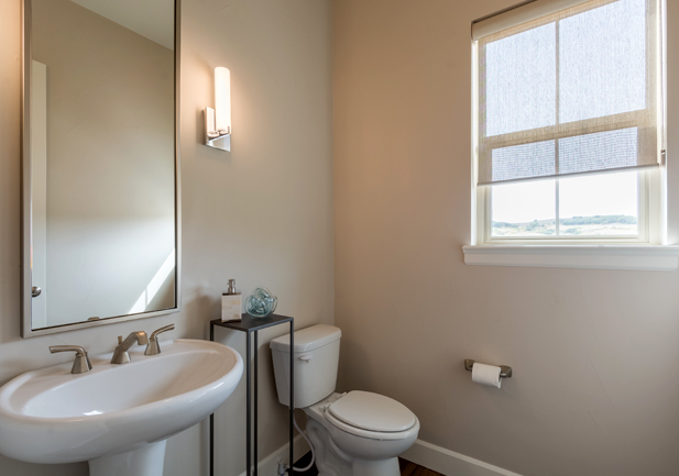 bathroom with screen roller shades on window in Littleton CO home