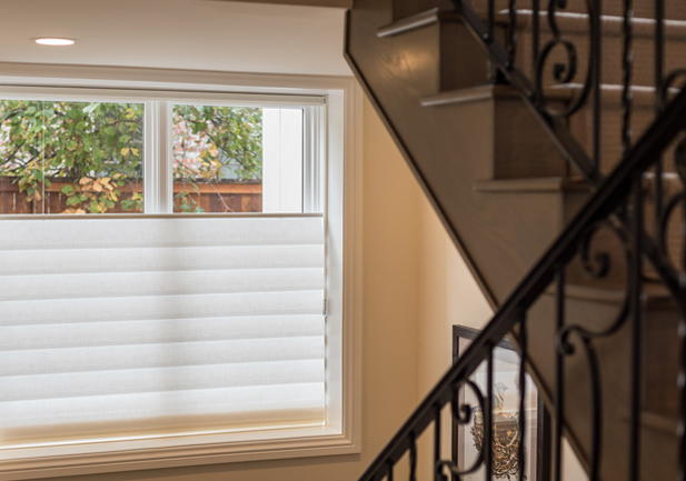 hardwood staircase white vignette top down roman shades on staircase window in Denver 80206