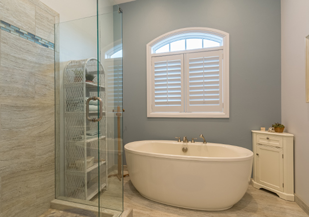 bathroom arched windows with plantation shutters in Denver CO