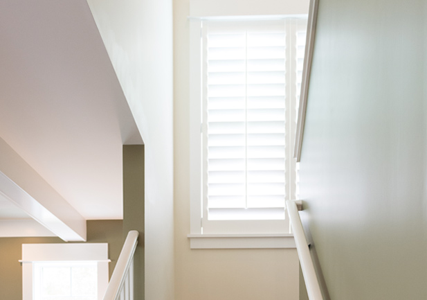 staircase white hardwood plantation shutters Hunter Douglas Denver 80206