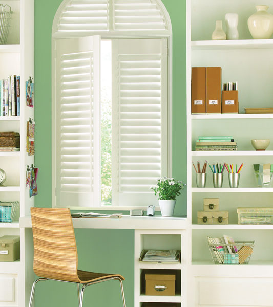 green home office with wall shelves and hunter doulgas white plantation shutters Denver