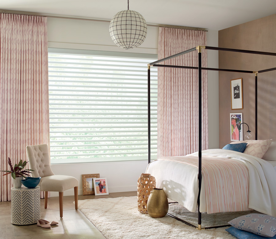 bedroom with pink draperies pinch pleat top layered shades on window Littleton CO