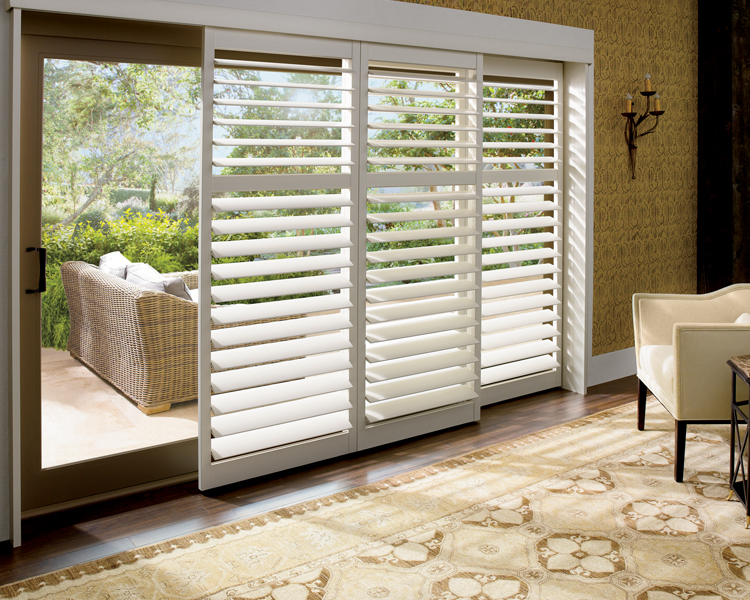 master bedroom with gold accent walls and sliding glass door hunter douglas plantation shutters Denver