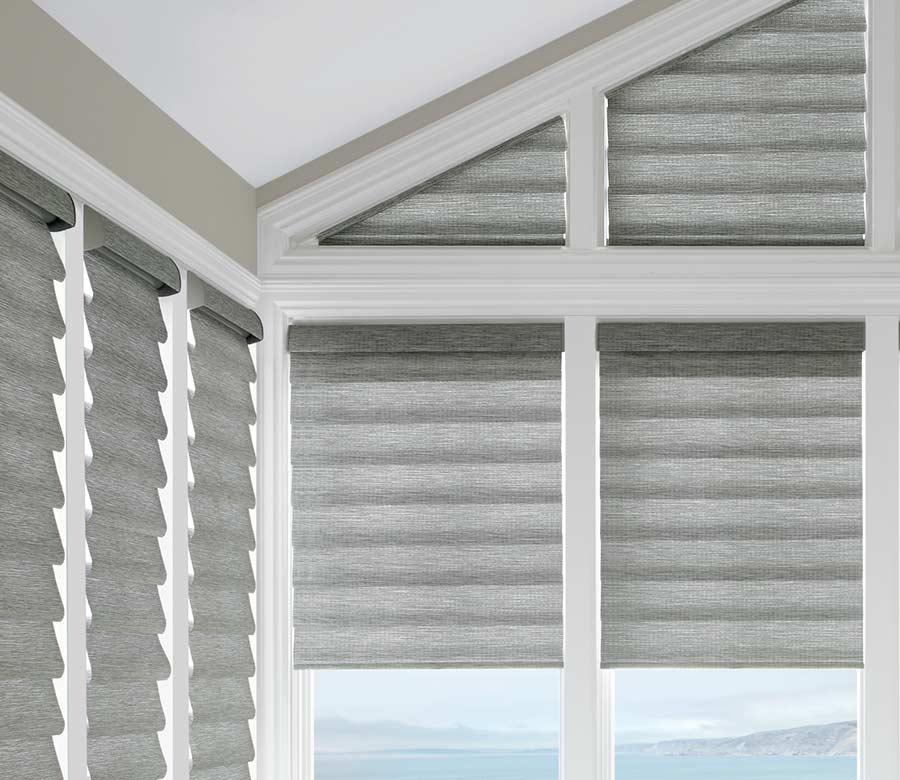 gray roman shades in corner window framed by white beams