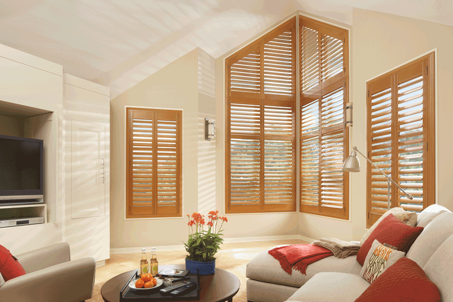 medium wood tone interior shutters for angled windows 