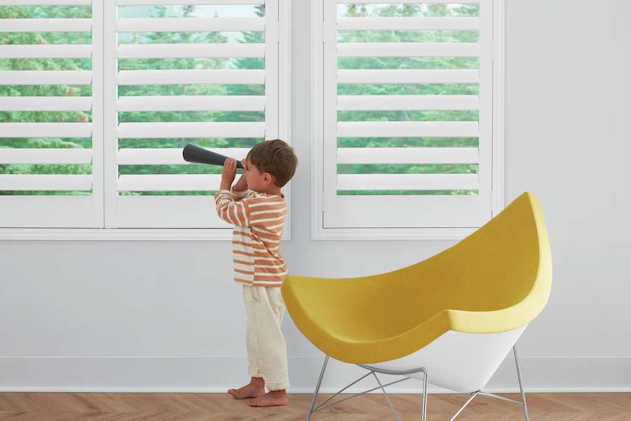 white plantation shutters in child's playroom how to childproof Denver CO