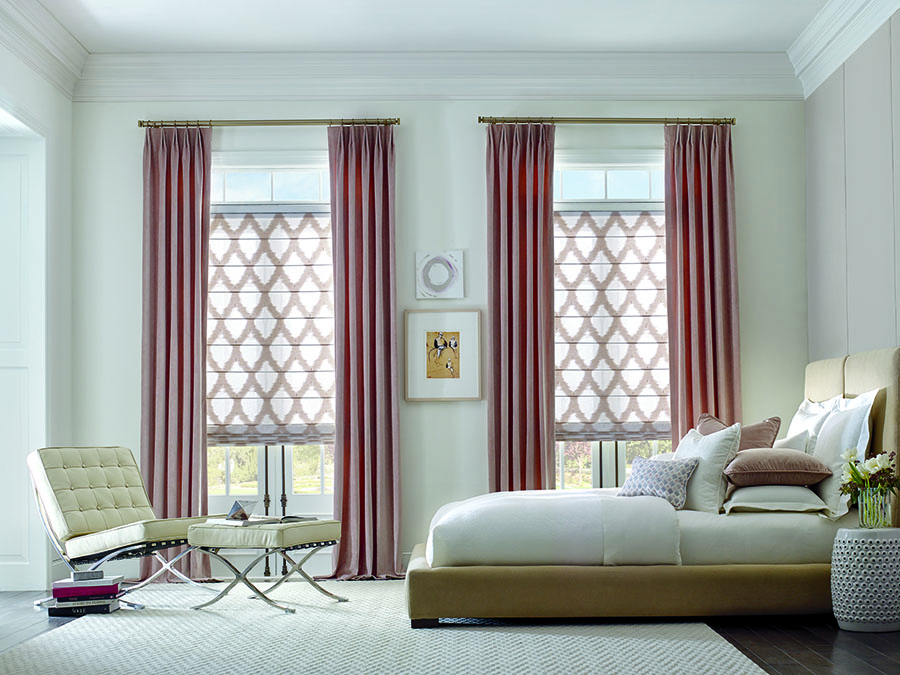 Pink drapes hung on gold hardware in bedroom.