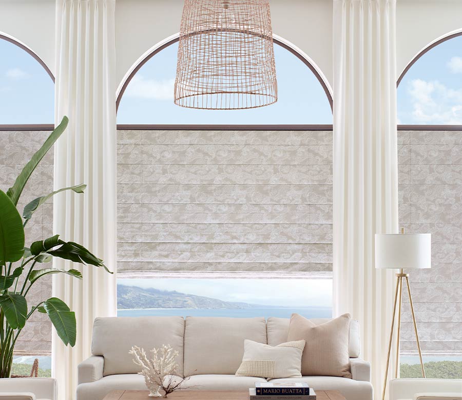 floor to ceiling arched windows in modern neutral living room