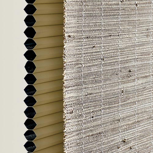 sideview of woven shade with a honeycomb dual shade behind