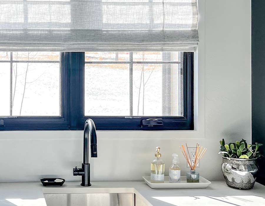kitchen sink window with gray roman shades in summit county, co