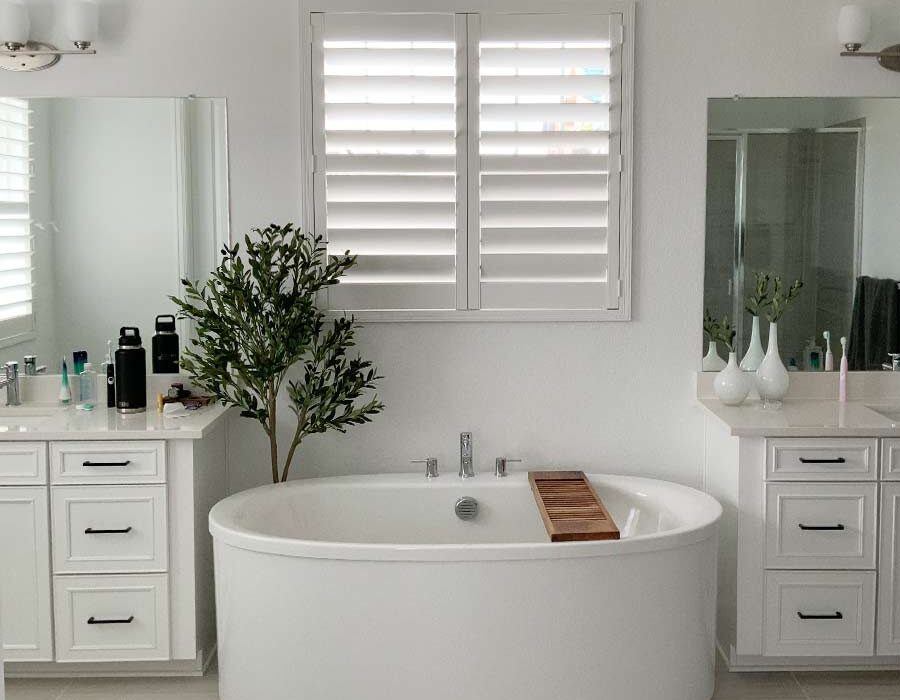 bathroom sunken tub with white plantation shutters in summit county, co