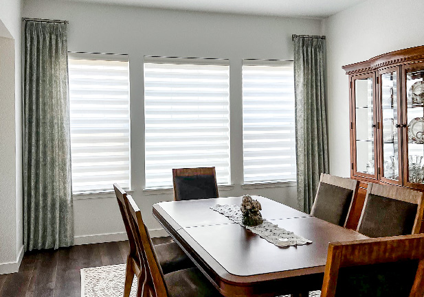 floor to ceiling drapery in dining room with mahogany chairs