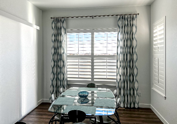 shutters on dining room windows and patterned drapery in Cherry Creek, CO