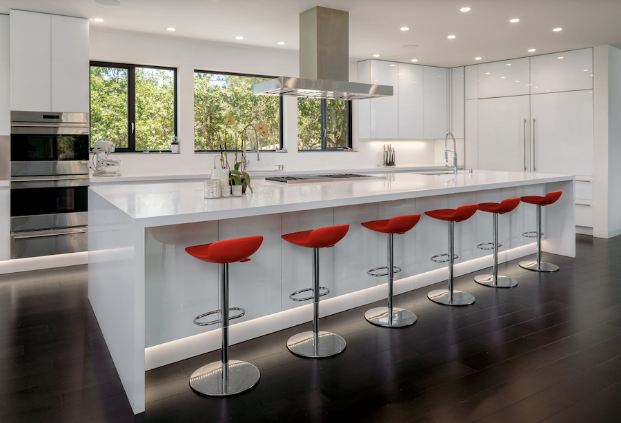 White modern kitchen with five red barstools