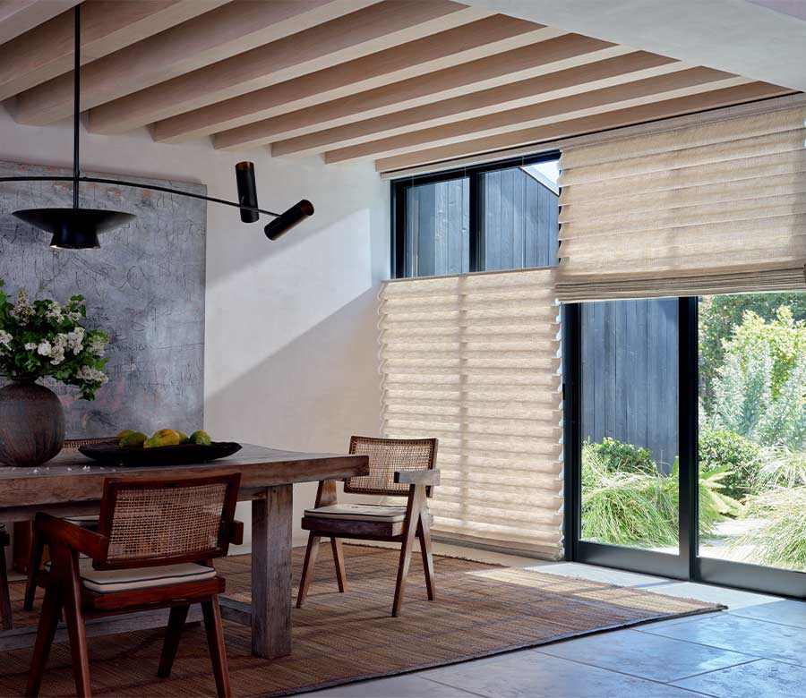 soft fabric window shades on black trim patio doors overlooking outdoor space