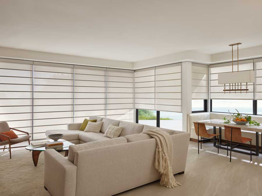 Alustra® Architectural Shades in a living area with floor to ceiling windows