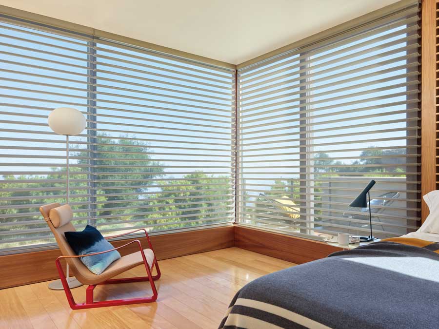 Silhouette® Windows Shades in a living room with floor to ceiling windows