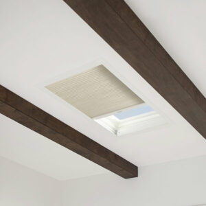 skylight shades on skylight window in white ceiling with beams