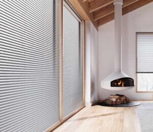 aluminum blinds on floor to ceiling windows in home with vaulted ceiling