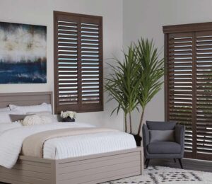 bedroom window shutters dark wood color in coastal inspired room