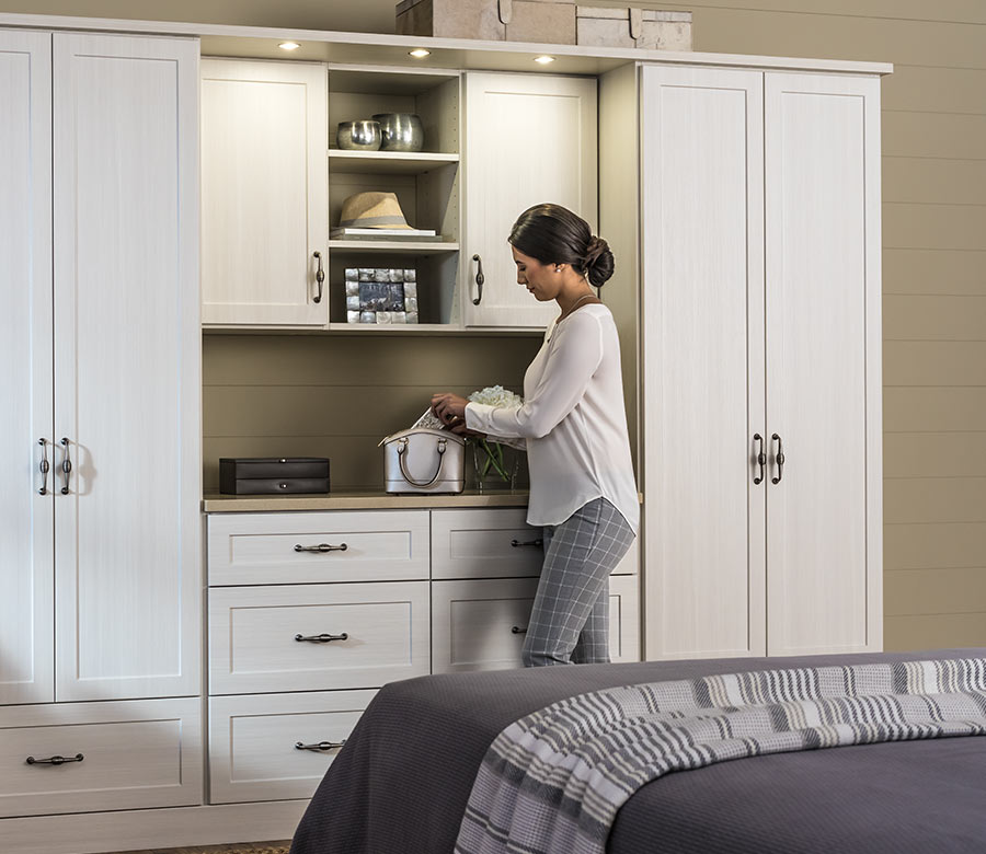 Custom bedroom closet storage with built-in shelving and cabinetry