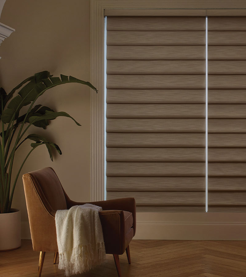 brown blackout shades vignette roman shades with leather chair in living room