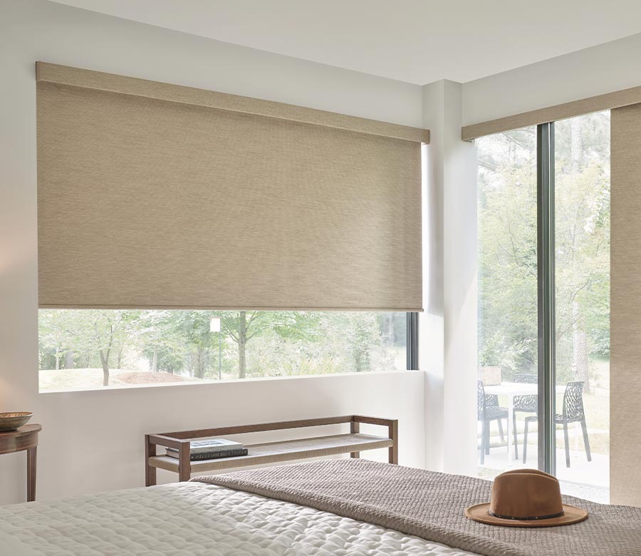 cream natural colored designer roller shades in bedroom