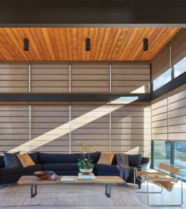 Brown custom window shades for large windows in living room floor to ceiling