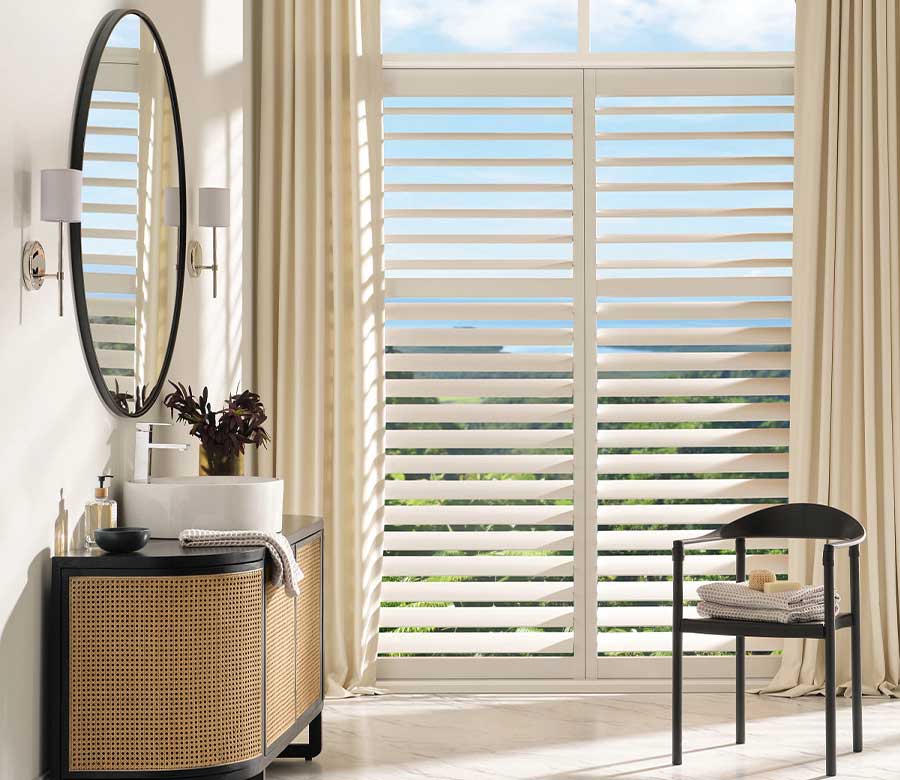 bathroom with palm beach vinyl shutters paired with custom drapery