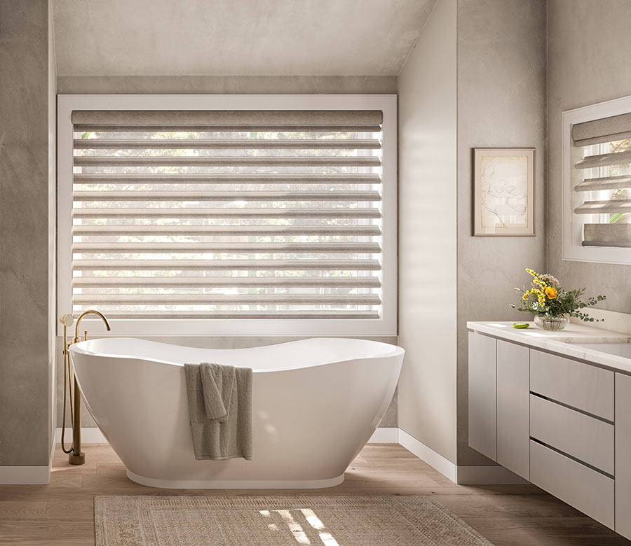 pirouette-window-treatments-primary-bathroom-suite-hunter-douglas-rocky-mountain-shutters-shades-and-closets bathroom with tub and pirouette window treatments