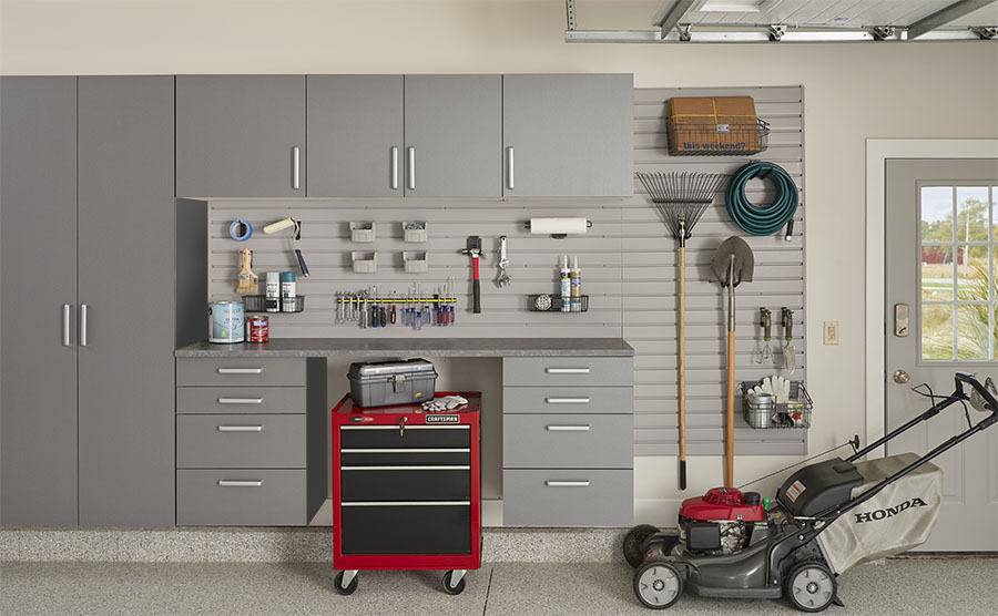 Custom garage storage with cabinets, slatwall, and organized equipment