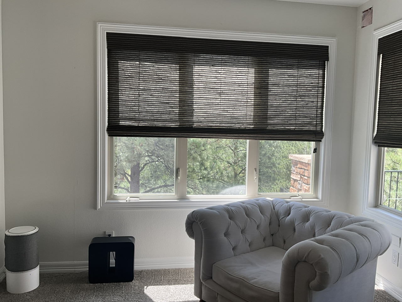 Bedroom before window treatment makeover with sunlight creating glare