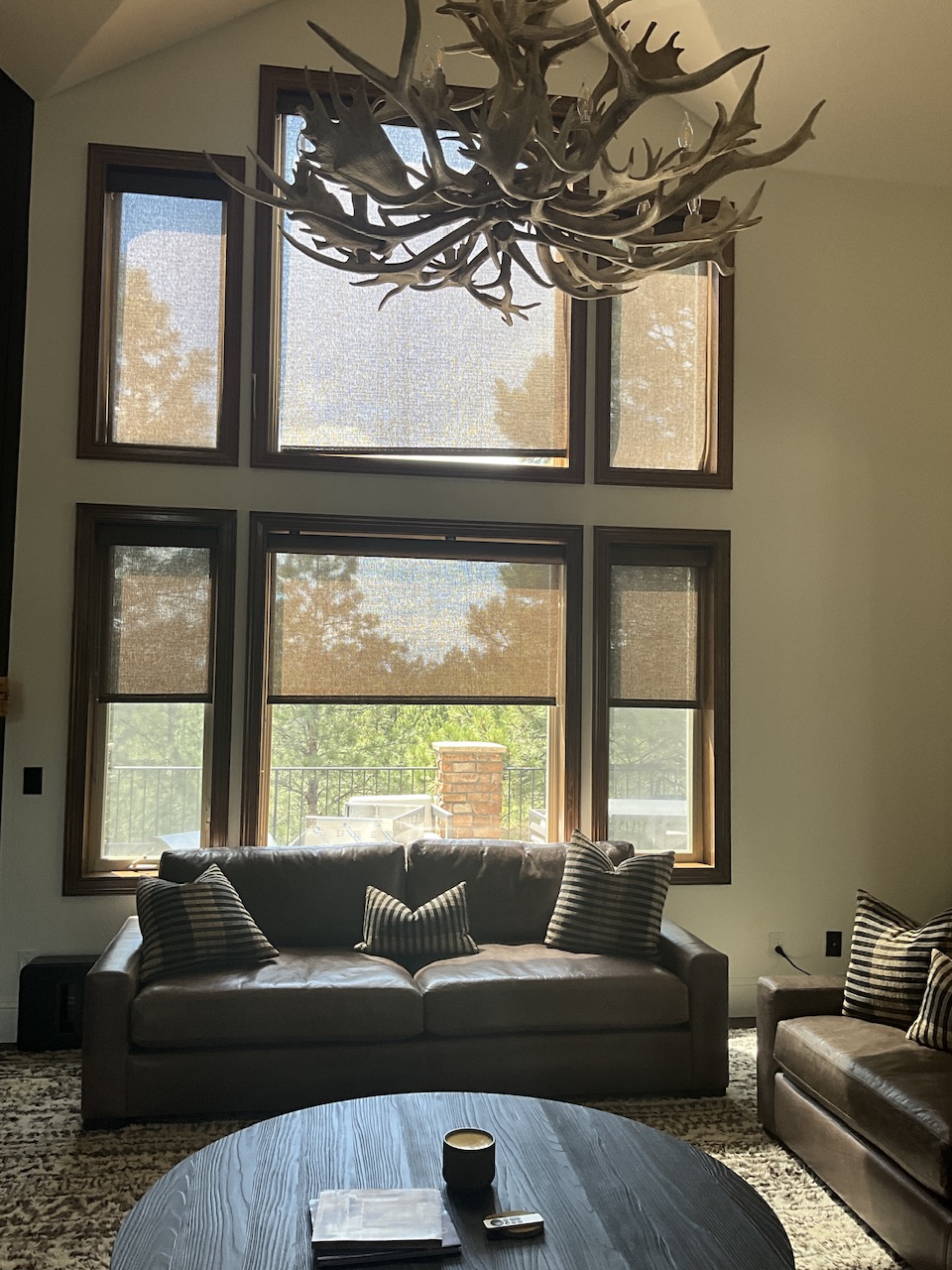Family room before window treatment update with existing coverings and limited light control