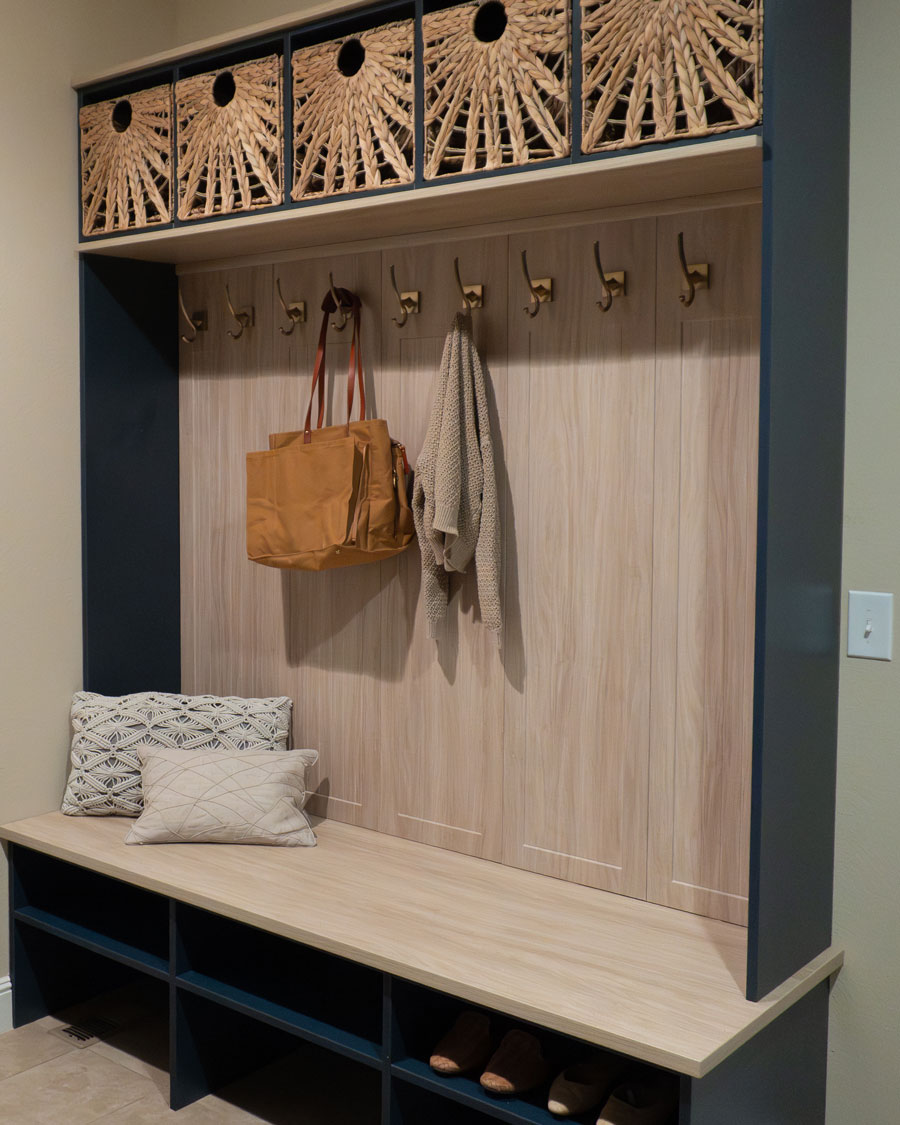 Custom mudroom with bench, cubbies, hooks, and built-in storage