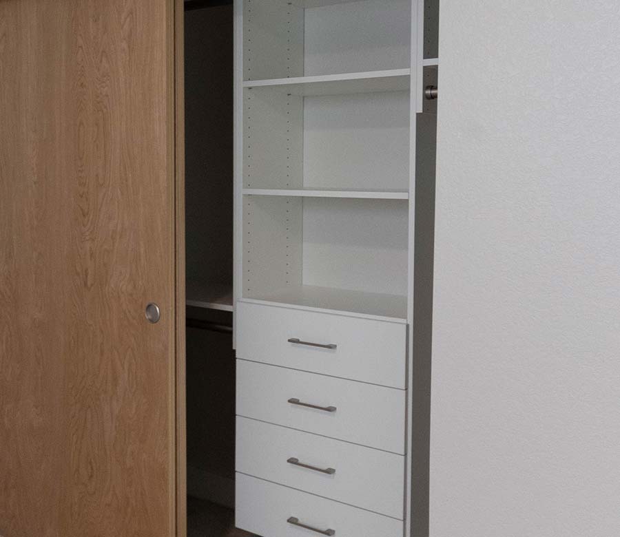 Longmont-CO-Bedroom-Reach-In-Closet-Drawers-Shelves-Rocky-Mountain-Shutters-Shades-Closets Custom reach-in bedroom closet with white shelving and drawers in Longmont, CO
