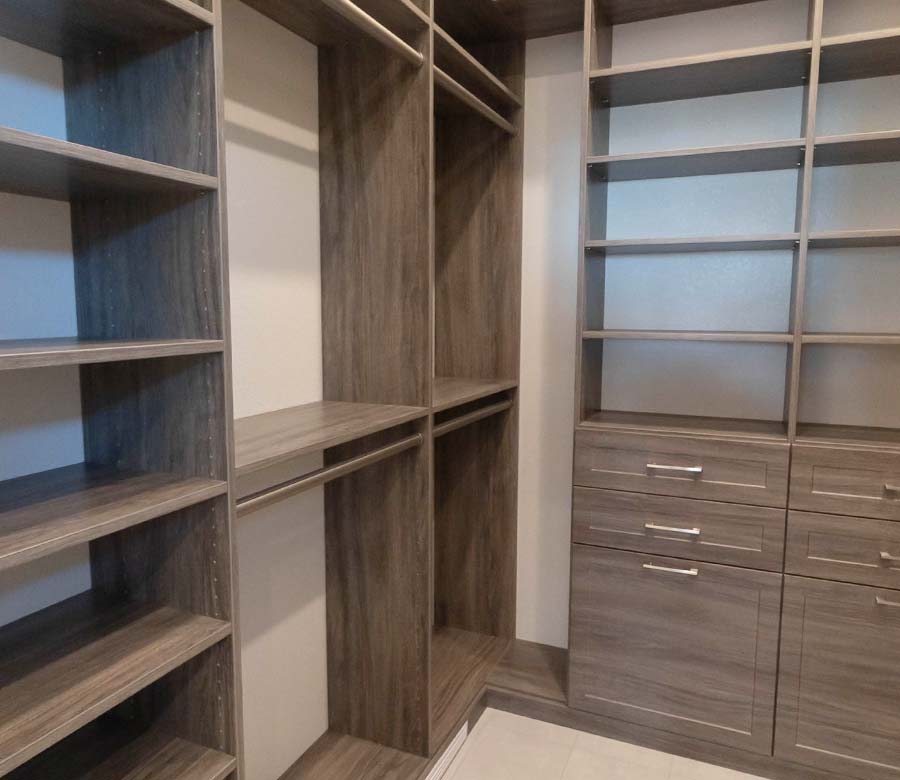Longmont-CO-Primary-Bedroom-Walk-In-Closet-Shelves-Drawers-Rocky-Mountain-Shutters-Shades-Closets Primary bedroom walk-in closet with Shaker drawers and built-in shelving in Longmont