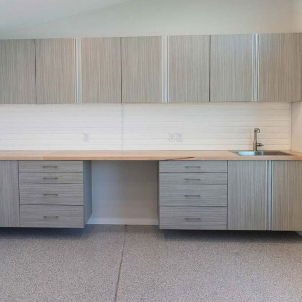 art-workshop-custom-storage-cabinets-rocky-mountain-shutters-shades-closets Custom art studio with built-in cabinetry, slatwall, desk, and workspace storage
