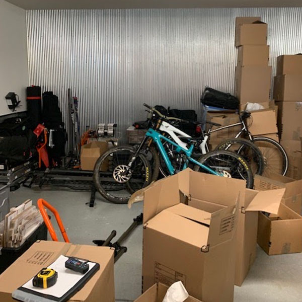 before-garage-storage-clutter-parker-colorado Parker CO garage before custom storage installation with boxes and bicycles