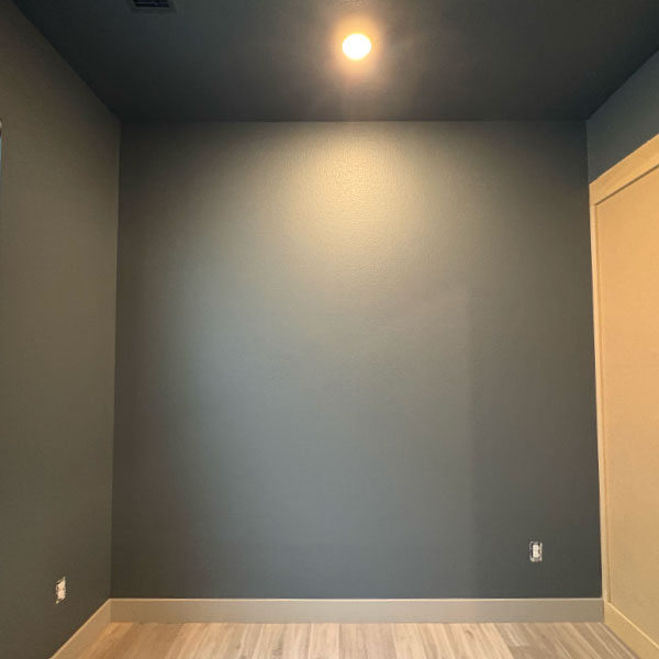 before installation of custom basement home office in Littleton, CO, with built-in desk, drawers, and upper cabinets.